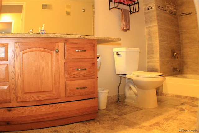 full bathroom with vanity, tiled shower / bath combo, and toilet