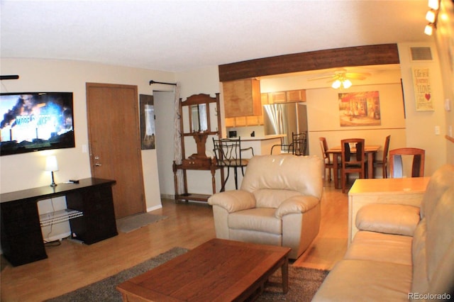 living room with hardwood / wood-style floors and ceiling fan