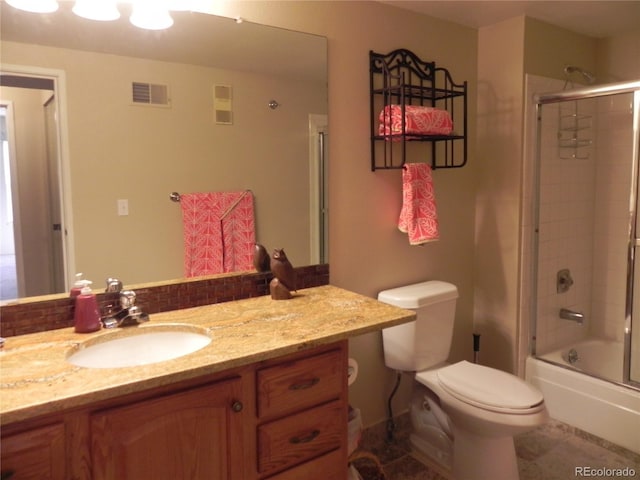 full bathroom featuring vanity, toilet, tile patterned flooring, and combined bath / shower with glass door