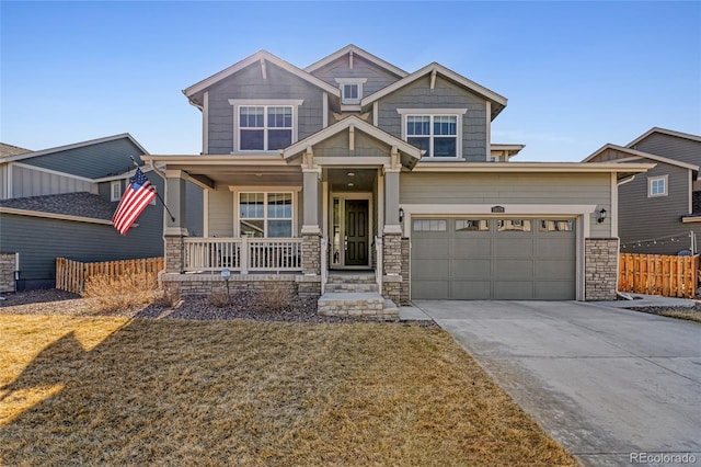 craftsman inspired home featuring driveway, stone siding, fence, covered porch, and a garage