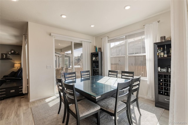 dining room featuring recessed lighting, light wood-type flooring, and baseboards