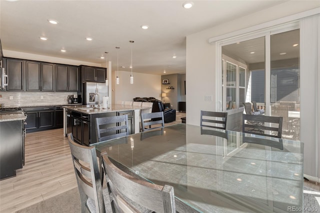 dining room featuring recessed lighting and light wood-style floors