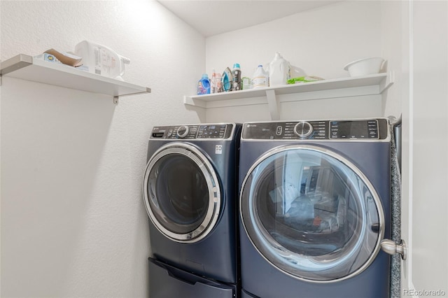 washroom featuring laundry area and washing machine and dryer