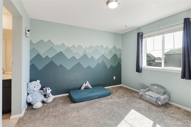 game room featuring light colored carpet, an accent wall, and baseboards