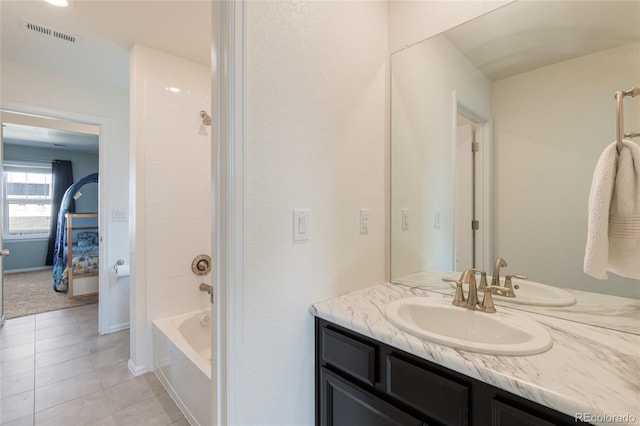 bathroom with visible vents, baseboards, tile patterned floors, vanity, and  shower combination