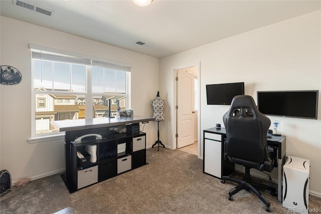 carpeted office space with visible vents and baseboards