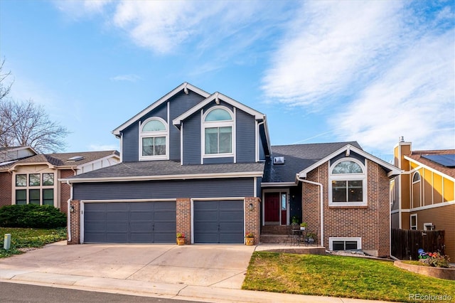 view of front of house featuring a front lawn and a garage