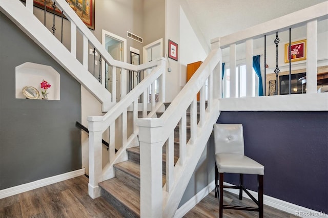 stairs featuring a fireplace and wood-type flooring