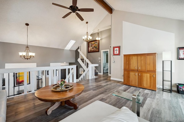 living room featuring beamed ceiling, ceiling fan with notable chandelier, light wood-type flooring, and high vaulted ceiling