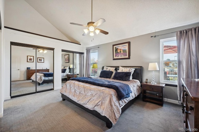 bedroom with multiple windows, carpet flooring, ceiling fan, and multiple closets