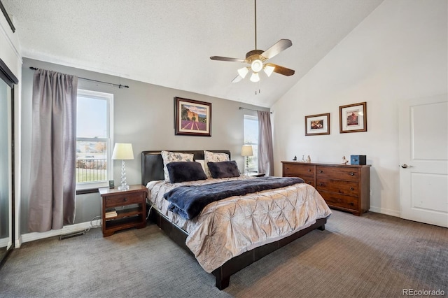 bedroom featuring dark colored carpet, ceiling fan, lofted ceiling, and a textured ceiling