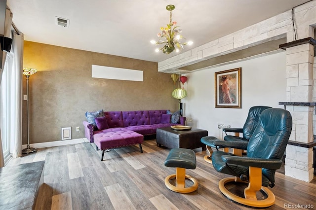 living room featuring a notable chandelier and light hardwood / wood-style floors