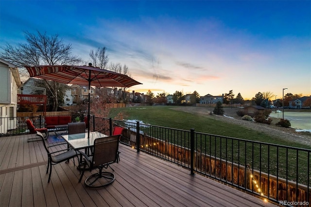 deck at dusk with a lawn