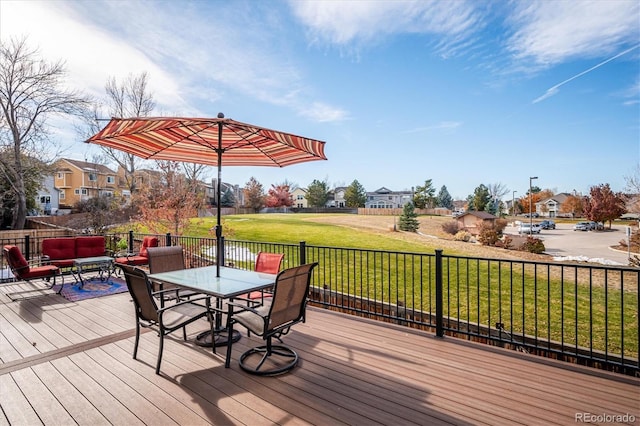 wooden deck featuring a lawn