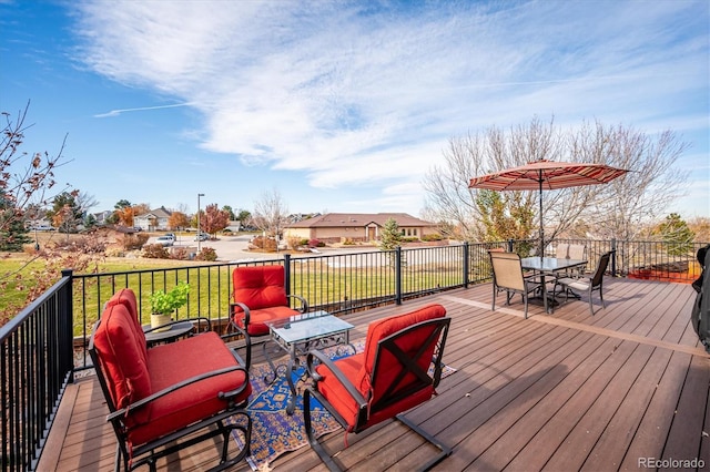 wooden deck featuring a lawn