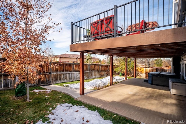 view of patio / terrace with a hot tub and a deck