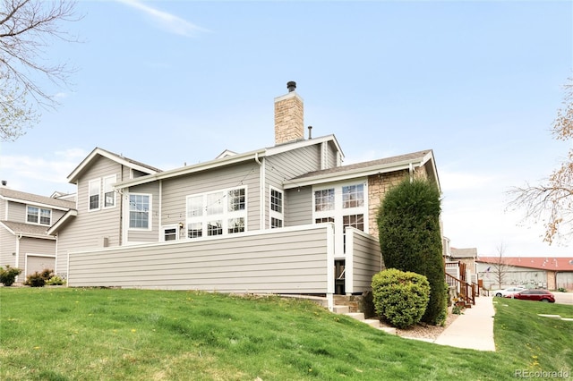 6858 Zenobia St Unit 9, Westminster, CO 80030 - back of property featuring a chimney and a yard