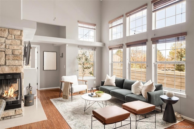 6858 Zenobia St Unit 9, Westminster, CO 80030 - living area with a towering ceiling, baseboards, wood finished floors, and a fireplace