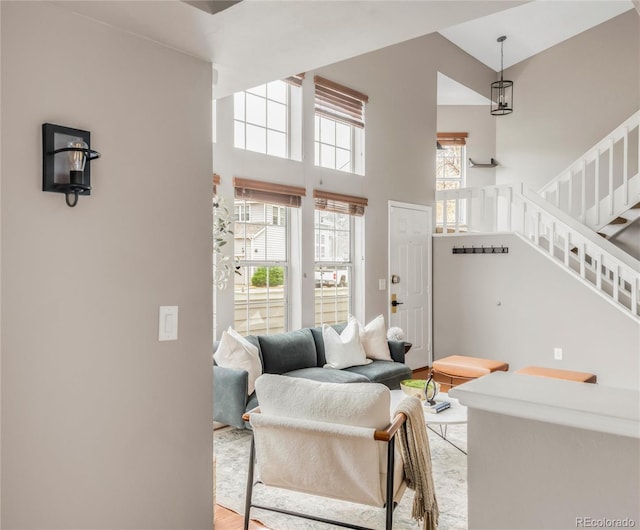6858 Zenobia St Unit 9, Westminster, CO 80030 - living room with healthy amount of natural light, stairway, light wood finished floors, and a high ceiling