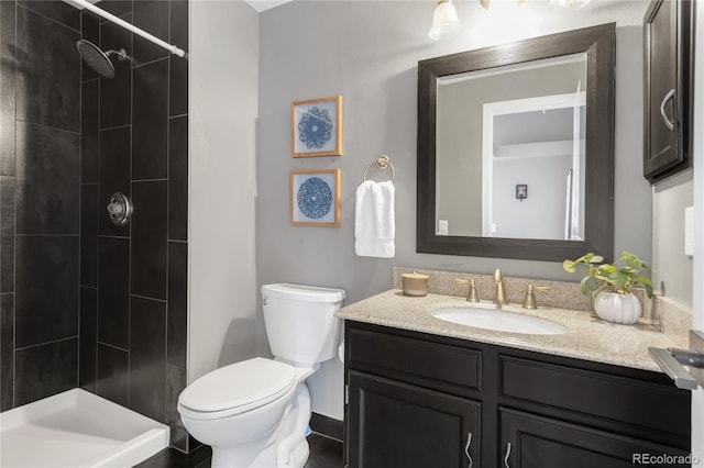 6858 Zenobia St Unit 9, Westminster, CO 80030 - bathroom with vanity, tiled shower, and toilet