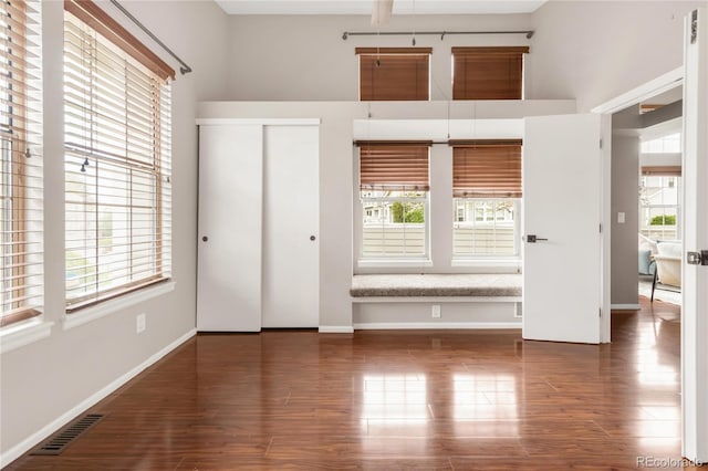 6858 Zenobia St Unit 9, Westminster, CO 80030 - unfurnished bedroom featuring wood finished floors, baseboards, and a closet