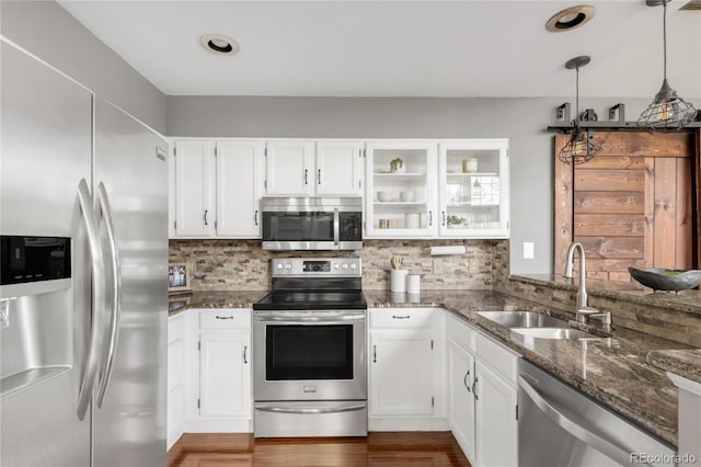 6858 Zenobia St Unit 9, Westminster, CO 80030 - kitchen with stainless steel appliances, a sink, dark stone counters, and white cabinets