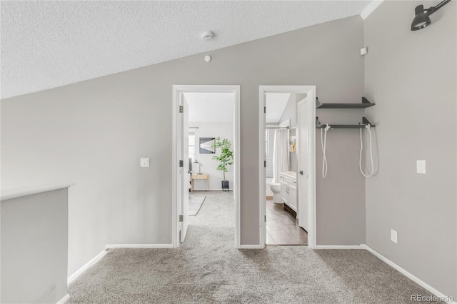 6858 Zenobia St Unit 9, Westminster, CO 80030 - unfurnished bedroom featuring vaulted ceiling, carpet, a textured ceiling, and baseboards