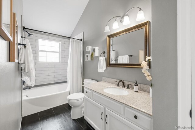 6858 Zenobia St Unit 9, Westminster, CO 80030 - bathroom featuring vaulted ceiling, toilet, tile patterned floors, vanity, and shower / tub combo with curtain