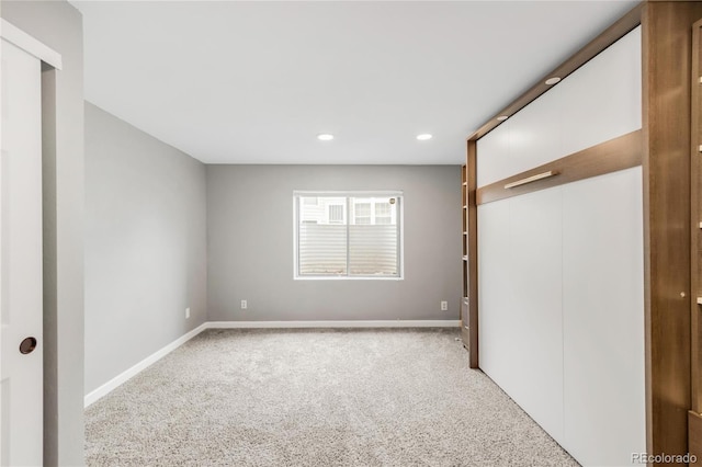 6858 Zenobia St Unit 9, Westminster, CO 80030 - unfurnished bedroom with light colored carpet, baseboards, recessed lighting, and a closet