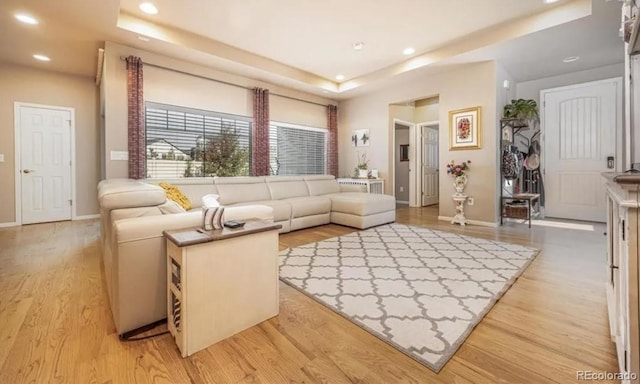 6765 Windbrook Ct, Colorado Springs, CO 80927 - living room featuring a tray ceiling, light wood-style flooring, and recessed lighting