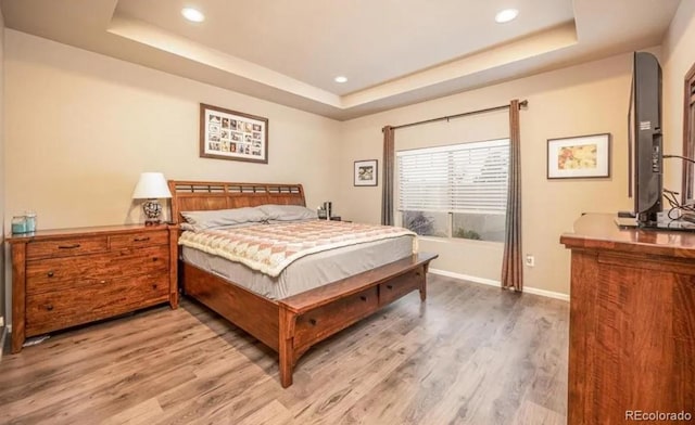 6765 Windbrook Ct, Colorado Springs, CO 80927 - bedroom with a raised ceiling, light wood finished floors, and recessed lighting
