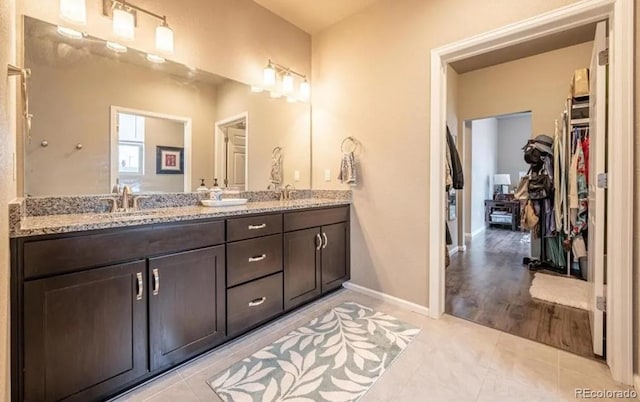 6765 Windbrook Ct, Colorado Springs, CO 80927 - bathroom with double vanity, tile patterned flooring, and a spacious closet