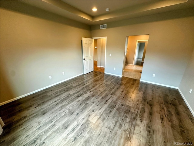6765 Windbrook Ct, Colorado Springs, CO 80927 - unfurnished bedroom featuring dark wood-type flooring, a raised ceiling, and recessed lighting