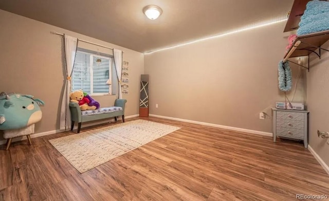 6765 Windbrook Ct, Colorado Springs, CO 80927 - sitting room featuring wood finished floors and baseboards