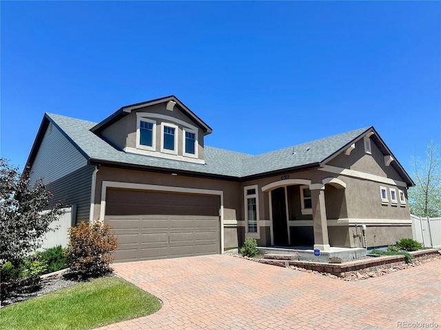 6765 Windbrook Ct, Colorado Springs, CO 80927 - view of front of home with stucco siding, decorative driveway, and roof with shingles