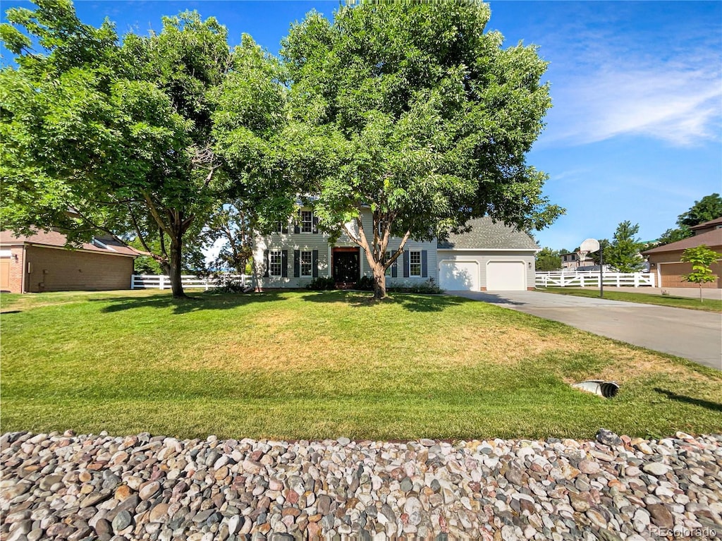 view of front of home with a garage and a front yard