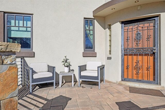 621 Kearney St, Denver, CO 80220 - property entrance featuring a patio area and stucco siding