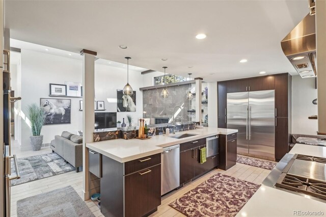 621 Kearney St, Denver, CO 80220 - kitchen featuring light countertops, ventilation hood, appliances with stainless steel finishes, and light wood-style flooring