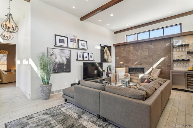 621 Kearney St, Denver, CO 80220 - living area featuring a notable chandelier, wine cooler, a tile fireplace, and light wood-type flooring