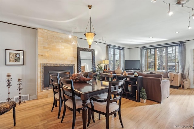621 Kearney St, Denver, CO 80220 - dining space with baseboards, a fireplace, light wood-type flooring, and visible vents