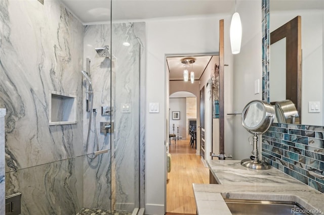 621 Kearney St, Denver, CO 80220 - bathroom featuring a marble finish shower and wood finished floors