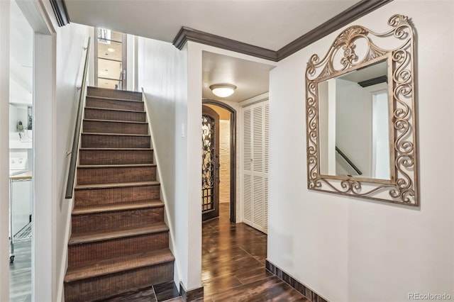 621 Kearney St, Denver, CO 80220 - stairs featuring crown molding, arched walkways, baseboards, and wood finished floors