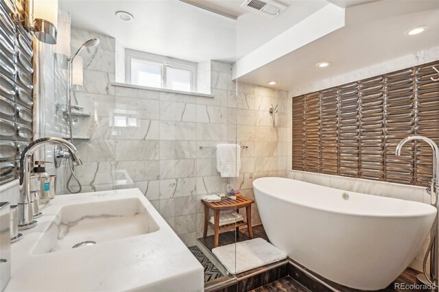 621 Kearney St, Denver, CO 80220 - bathroom featuring a freestanding tub, visible vents, a tile shower, and a sink