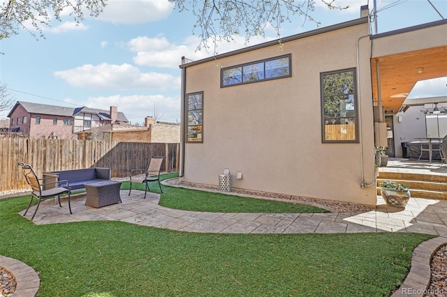 621 Kearney St, Denver, CO 80220 - back of property featuring fence, stucco siding, an outdoor hangout area, a patio area, and a lawn