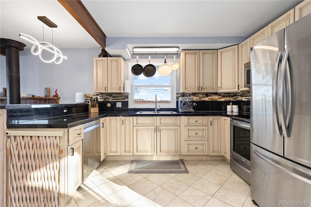 kitchen with light tile patterned flooring, sink, decorative light fixtures, appliances with stainless steel finishes, and decorative backsplash