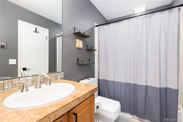 bathroom featuring vanity, curtained shower, and toilet