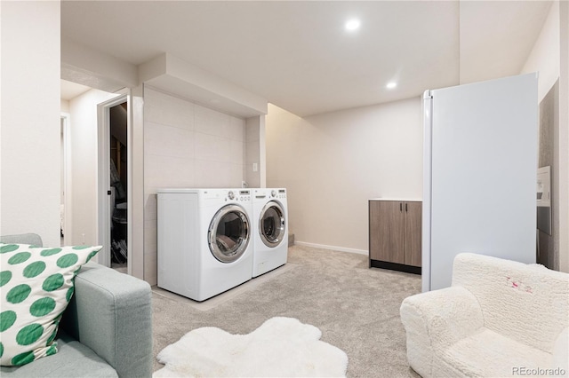 washroom featuring light colored carpet and washing machine and dryer