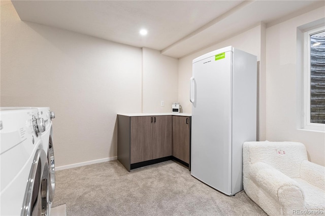 laundry area with light carpet and washing machine and dryer