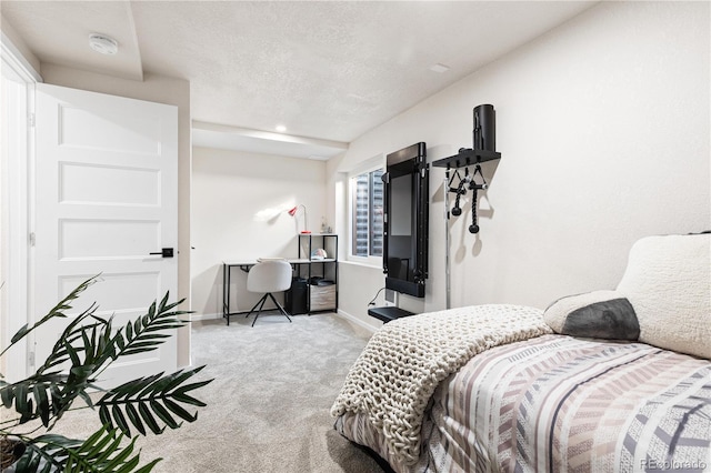 bedroom with light colored carpet and a textured ceiling