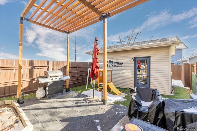 view of patio / terrace with a grill and an outdoor structure